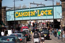 image of busy camden high street capturing famous camden lock overhaead railway bridge.
